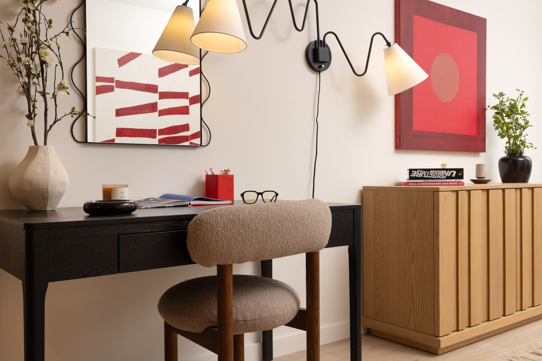 Slim desk seating area with modern fixtures and art