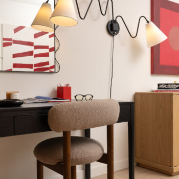 Slim desk seating area with modern fixtures and art