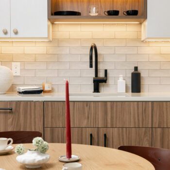 Kitchen detail showing sink with dark fixtures, White Upper/Dark Walnut cabinets