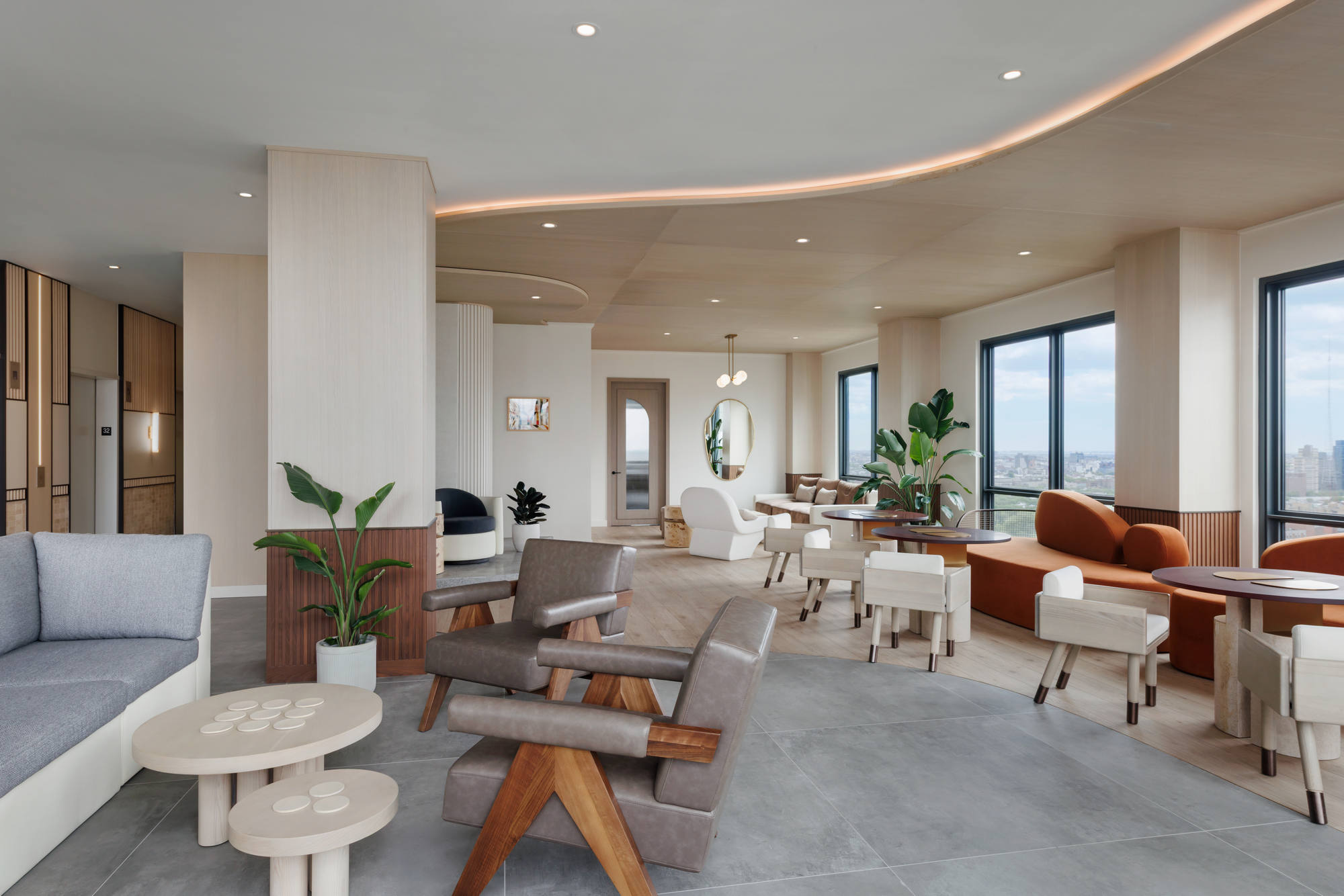 Expansive resident sunset lounge showcasing fluid wood-veneer ceilings, an array of mid-century styled armchairs and curved sofas, and large windows providing panoramic city views.